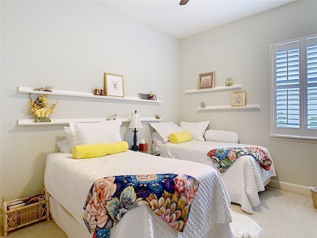 bedroom with carpet, baseboards, and ceiling fan