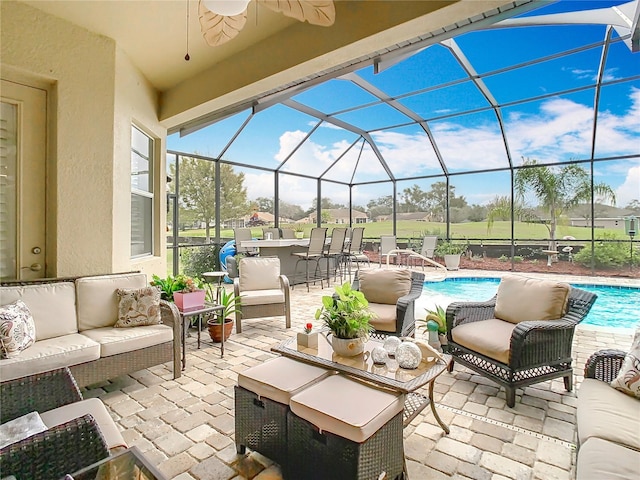 view of patio featuring outdoor dry bar, an outdoor hangout area, glass enclosure, ceiling fan, and an outdoor pool