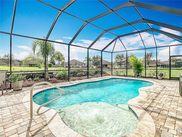 outdoor pool with a patio, a lanai, and a residential view