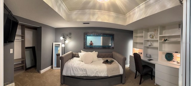 bedroom featuring visible vents, light carpet, ornamental molding, baseboards, and a raised ceiling