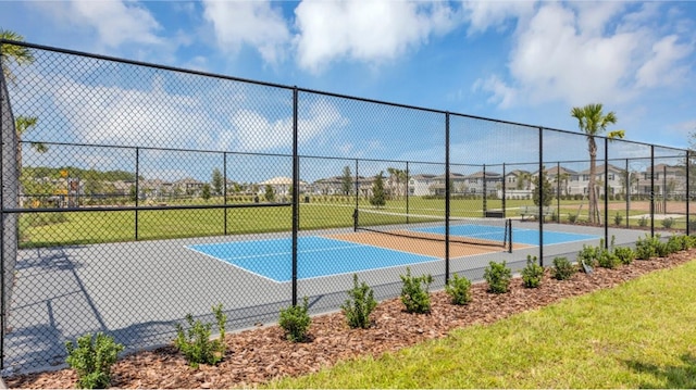 view of sport court featuring fence