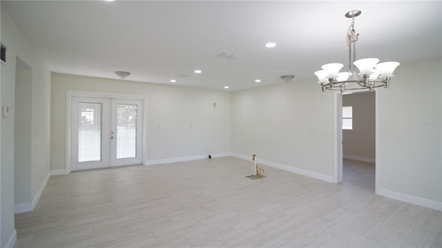 spare room with french doors, light wood-style flooring, and a wealth of natural light