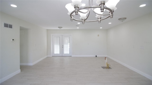 empty room with recessed lighting, visible vents, baseboards, french doors, and an inviting chandelier