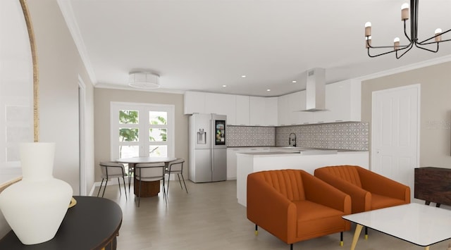 kitchen with white cabinetry, light countertops, stainless steel refrigerator with ice dispenser, range hood, and crown molding