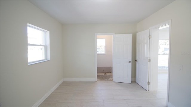 unfurnished room featuring baseboards