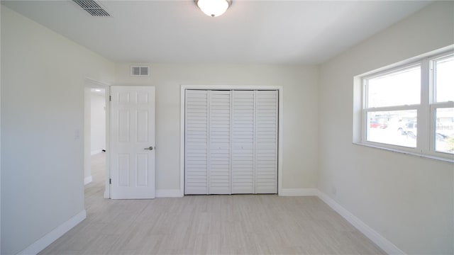 unfurnished bedroom featuring visible vents and baseboards