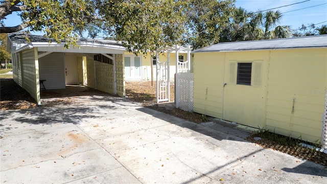 exterior space with driveway and a carport