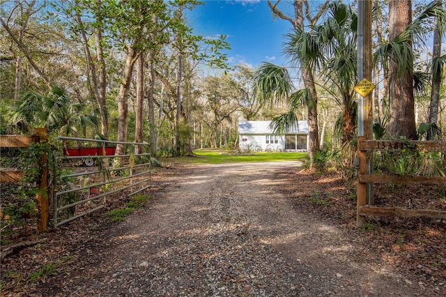 view of road featuring driveway, a gate, and a gated entry