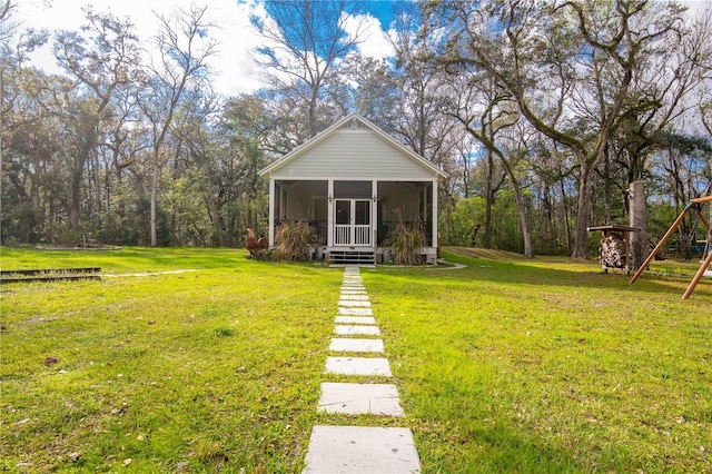 view of yard with a sunroom and a playground