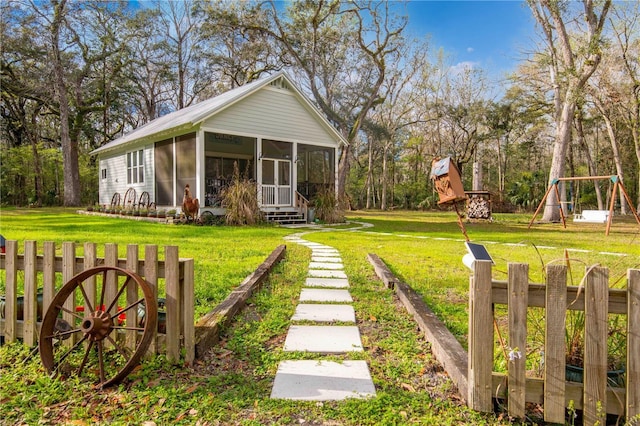 exterior space featuring a playground and a sunroom