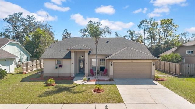 view of front of property featuring fence, driveway, a front lawn, and stucco siding