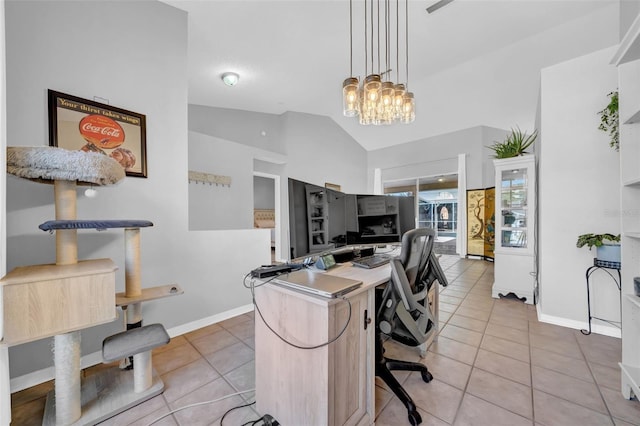 kitchen featuring lofted ceiling, light tile patterned flooring, hanging light fixtures, and baseboards