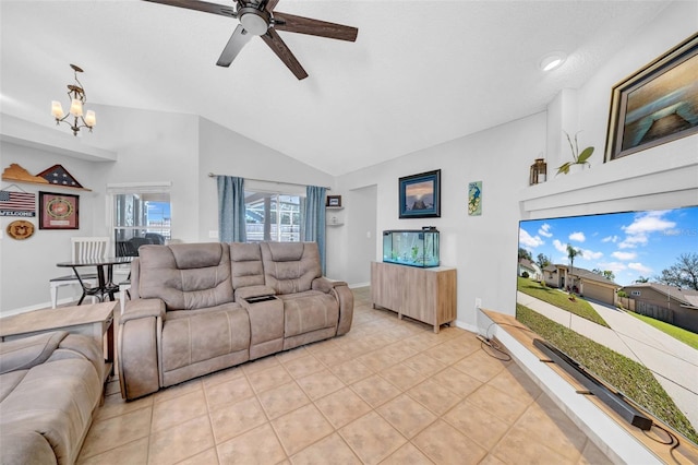 living area with lofted ceiling, light tile patterned floors, baseboards, and ceiling fan with notable chandelier