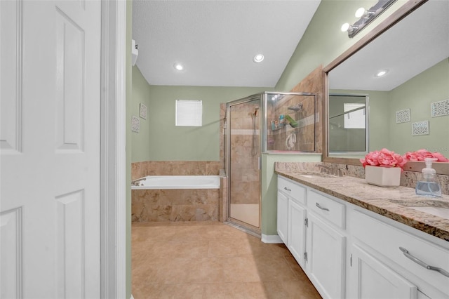 full bathroom with a garden tub, tile patterned floors, a sink, and a stall shower