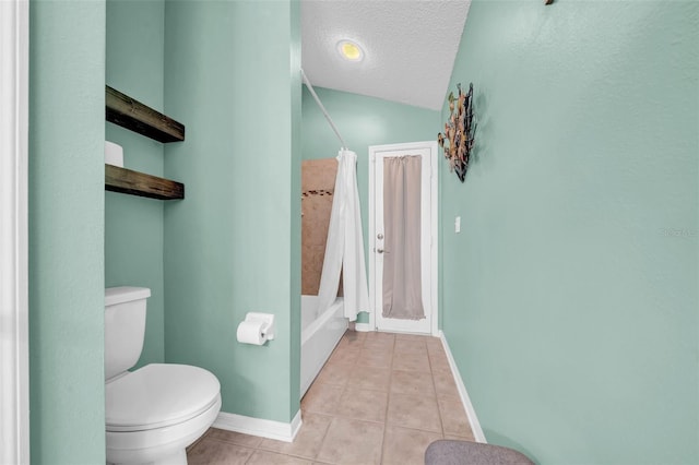 bathroom featuring baseboards, toilet, tile patterned floors, a textured ceiling, and shower / bath combination with curtain