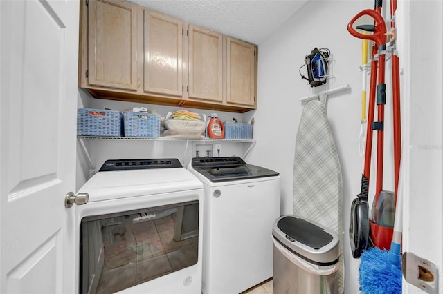 laundry area with a textured ceiling, cabinet space, and washer and dryer