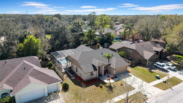 drone / aerial view with a residential view and a forest view