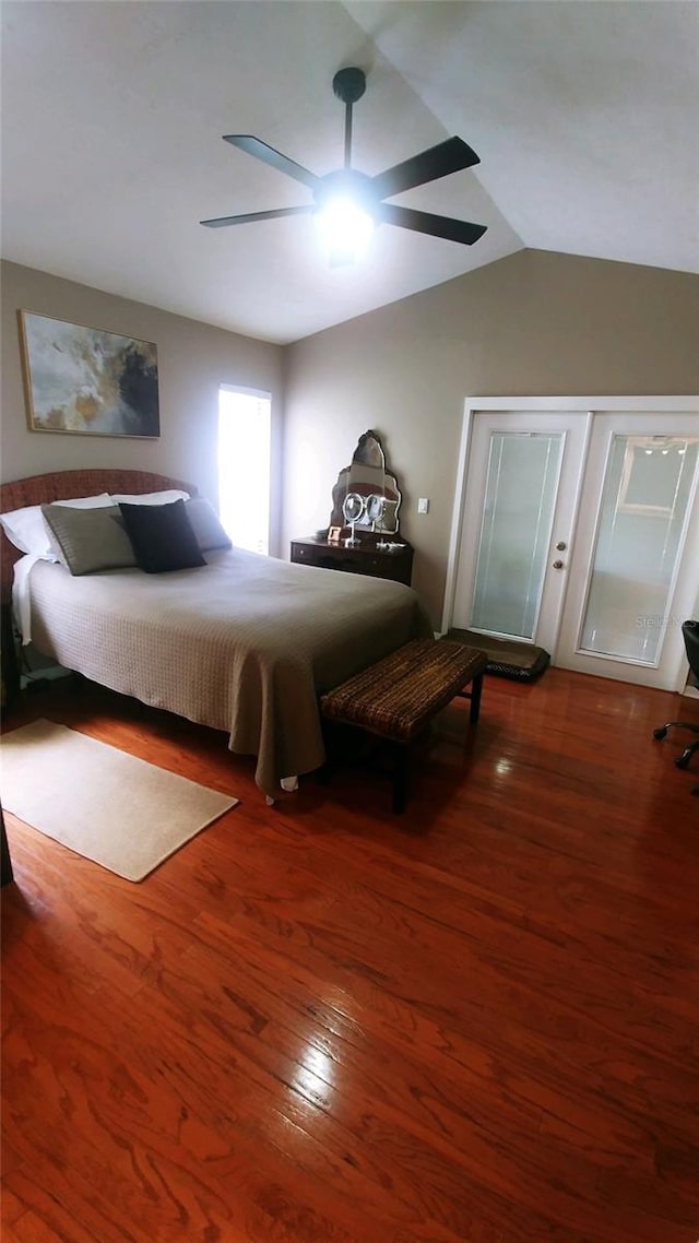 bedroom with ceiling fan, vaulted ceiling, and wood finished floors