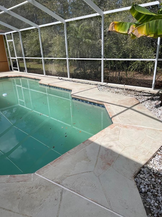 outdoor pool featuring a lanai and a patio area