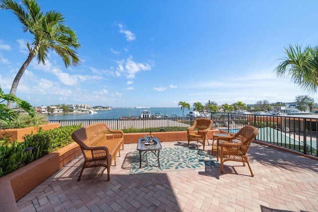 view of patio / terrace with a water view and fence