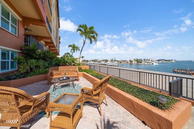 view of patio featuring a water view and an outdoor living space