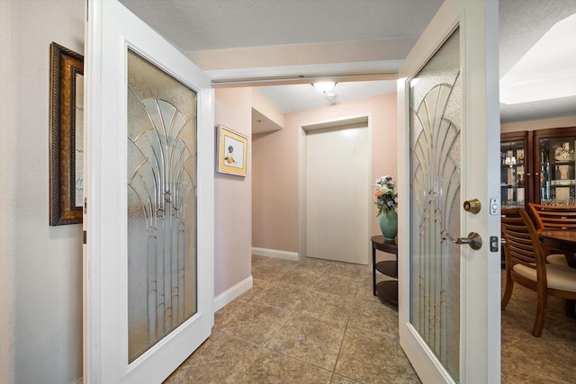 hallway featuring baseboards