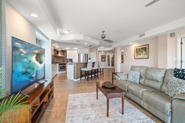 living room featuring light tile patterned floors, visible vents, a ceiling fan, and recessed lighting