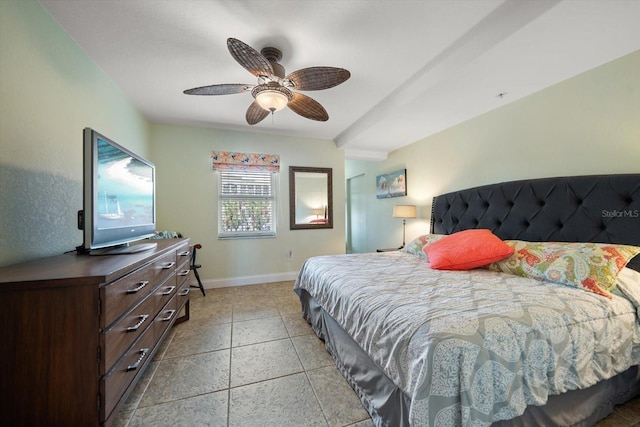 bedroom with light tile patterned flooring, a ceiling fan, and baseboards