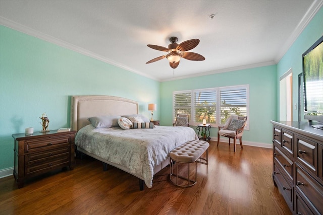 bedroom featuring baseboards, ornamental molding, dark wood finished floors, and a ceiling fan