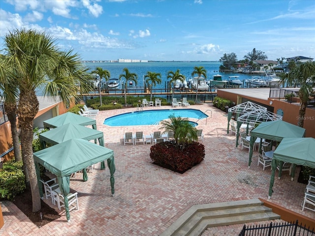 pool featuring a water view and fence