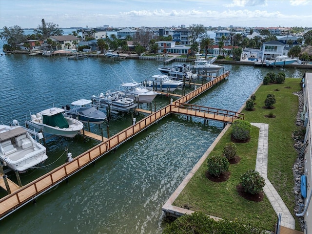 view of dock featuring a yard, a water view, and boat lift