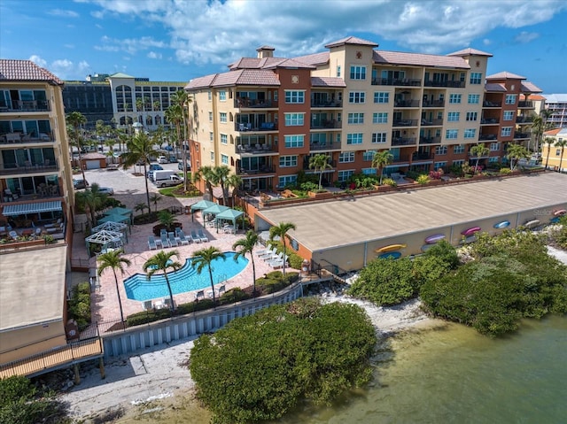 view of property with a water view and a community pool