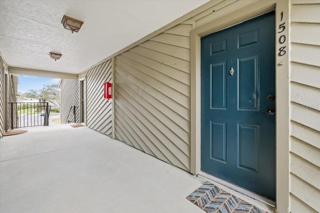 view of exterior entry with a porch