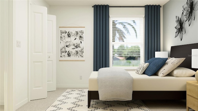 bedroom featuring baseboards and light colored carpet