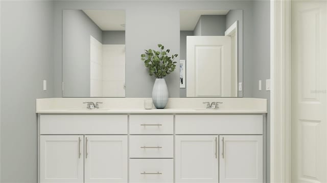 bathroom featuring a sink and double vanity