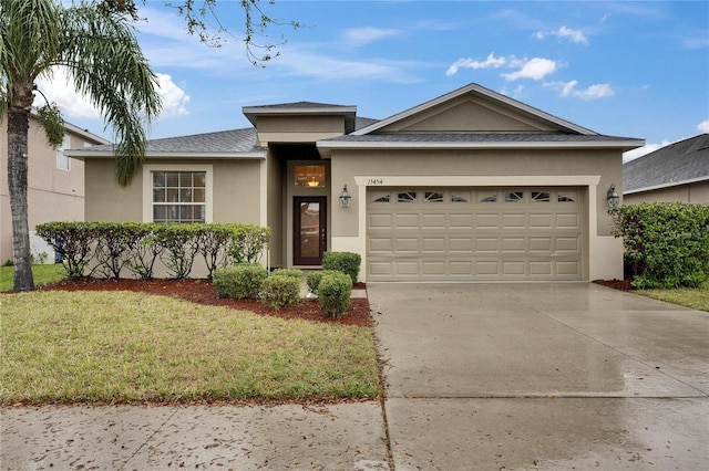 ranch-style home with a garage, concrete driveway, a front lawn, and stucco siding