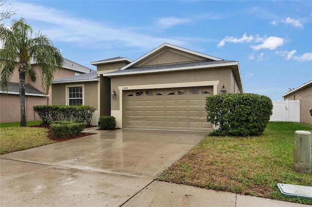 ranch-style home with a garage, driveway, a front yard, and stucco siding