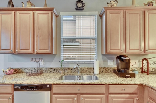 kitchen featuring light brown cabinets, dishwasher, a sink, and light stone countertops