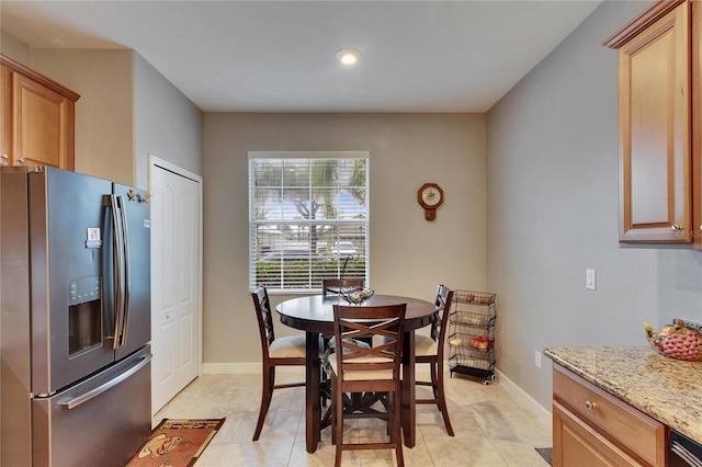 dining room featuring light tile patterned flooring and baseboards