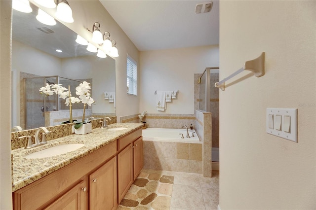 full bathroom featuring a garden tub, tiled shower, a sink, and visible vents