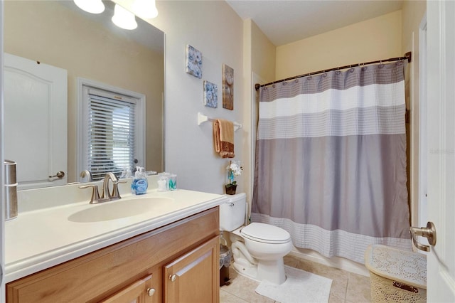 full bath featuring toilet, vanity, and tile patterned floors