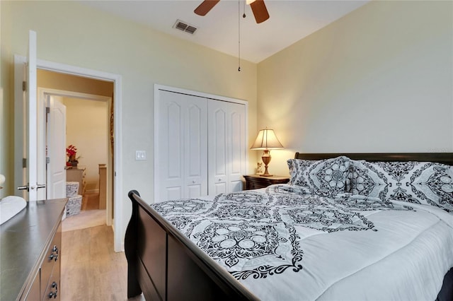 bedroom featuring a ceiling fan, light wood-style flooring, visible vents, and a closet