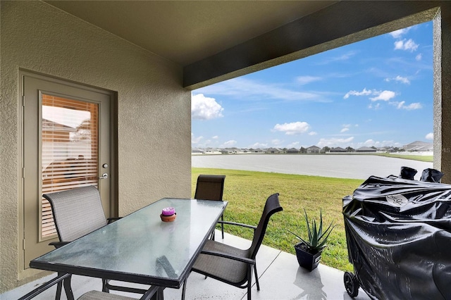 view of patio / terrace featuring a water view and outdoor dining space