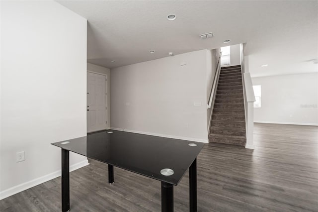 playroom with dark wood-style floors, visible vents, and baseboards