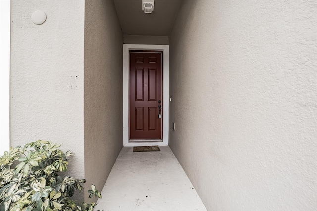 property entrance featuring stucco siding