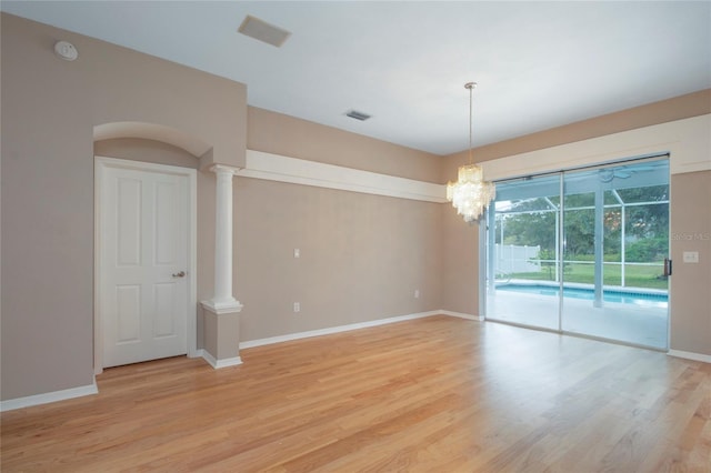 spare room featuring visible vents, light wood-type flooring, and baseboards