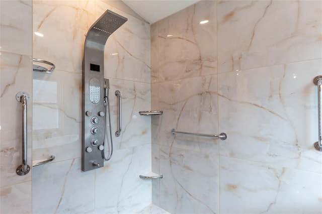 full bath with a marble finish shower