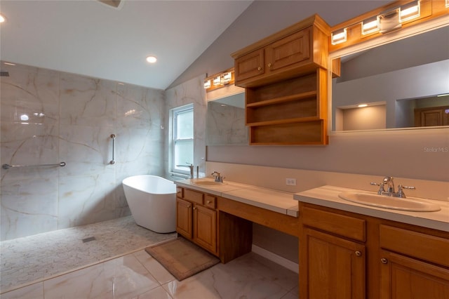 full bathroom featuring a soaking tub, vaulted ceiling, marble finish floor, and a sink