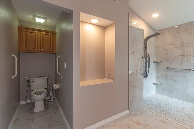 full bathroom featuring a marble finish shower, marble finish floor, baseboards, and vaulted ceiling