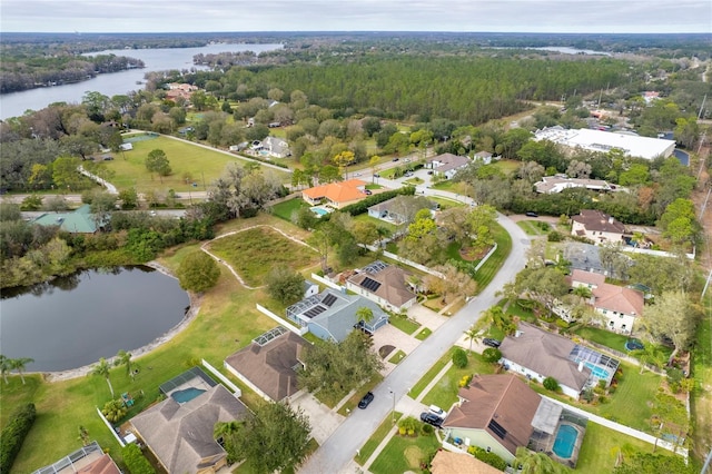 aerial view featuring a residential view, a view of trees, and a water view